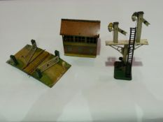 A box of 00 gauge tinplate railway signals, level crossing, water tower, station signal box etc