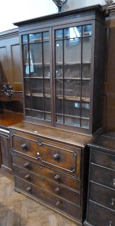 Victorian oak secretaire bookcase, with glazed cupboards enclosing five shelves to hinged drop flap,