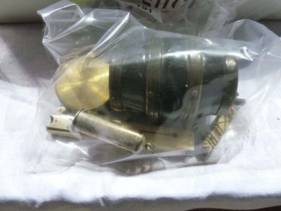 An  ivory cigar cutter, brass cased pocket compass, a treen miniature beer barrel, miniature ivory