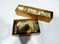 Old boxed set ebony and ivory dominoes in wooden case with sliding top and an alphabet game in