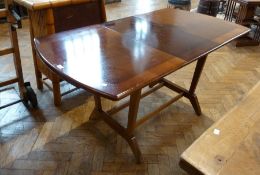 Modern mahogany extending dining table, rectangular shaped, on tapering supports united by