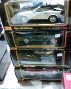A 1-18 scale Maisto Mercedes Benz SLK230, a Mercedes Benz SLK230, a BMW 502 and an Aston Martin