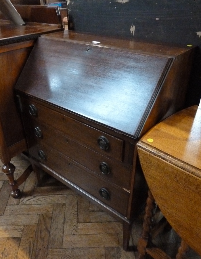 Twentieth century mahogany bureau, hinged top enclosing an array of pigeonholes and drawers, to