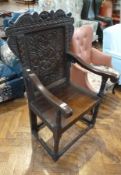 Seventeenth century style carved oak armchair, with foliate carved crestrail and central panel,