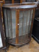Oak and glazed demi-lune side display cabinet, single door enclosing three glass shelves, on