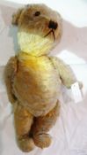 Twentieth century gold plush teddy bear, with stitched snout,  jointed limbs, (some wear), 51cm long