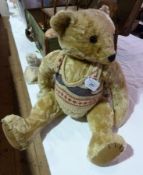 Modern reproduction pale gold teddy bear, with growl, hump back, long arms, glass eyes and