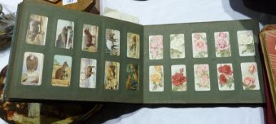 An album of cigarette cards, Wills and Players, steam engines, military badges, roses, wild