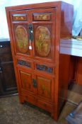 Chinese red lacquered wall cabinet, panelled cupboards above depicting various scenes, carved