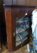 Mahogany hanging corner cupboard, astragal glazed door enclosing four shelves, 70cm wide