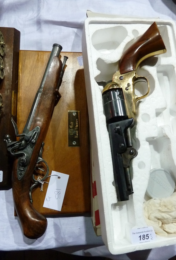 A replica Colt revolver, Navy Sherriff 1851, with wall mount,  together with a replica flintlock