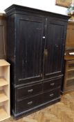 Large black painted  pine bachelor's cupboard, with pair panelled doors enclosing hanging space,