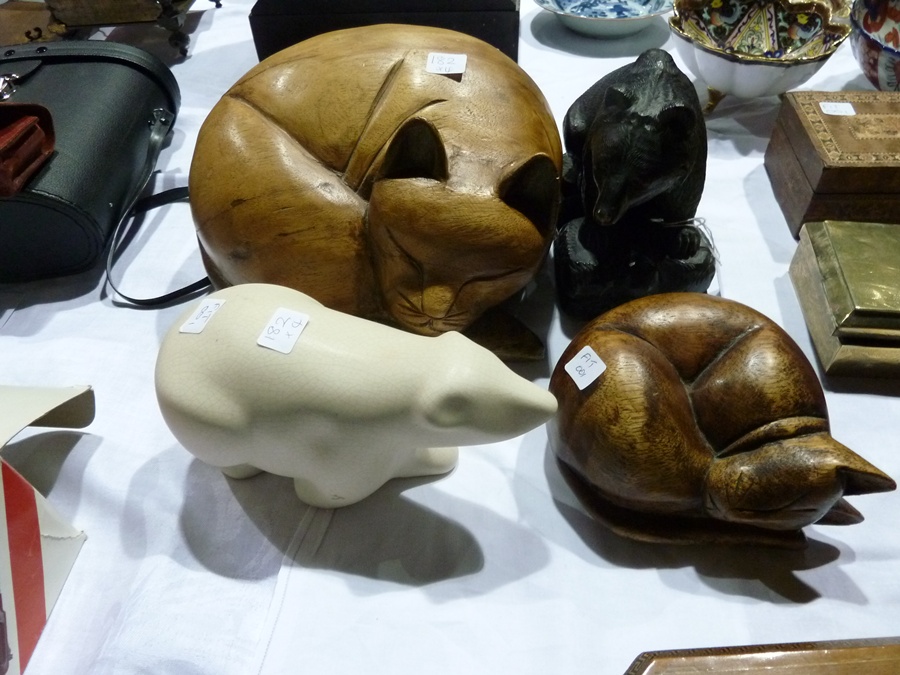 Carved wooden figure of a bear, two wooden figures of sleeping cats and a ceramic model of a polar