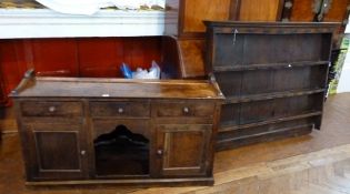 19th century oak dresser with boarded back having three open shelves, ogee frieze, three short