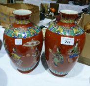 Pair Chinese porcelain vases, ovoid and decorated with ladies in various pursuits on madder