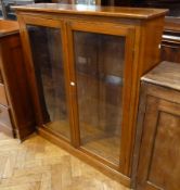 A mahogany glazed cabinet, enclosing four shelves on plinth base, 106cm wide