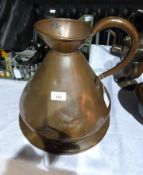 A large Victorian copper measuring jug on circular swivelling base