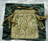 Nineteenth century silkwork bag, embroidered with floral emblems of Great Britain and having side