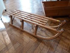 A vintage wooden sledge with metal runners