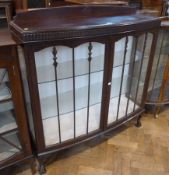 Twentieth century oak and glazed display cabinet, glazed doors decorated with foliate carved