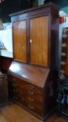 19th century mahogany library bureau bookcase having lozenge inlaid and cavetto pediment, plain