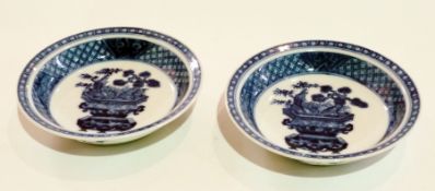 Pair Chinese porcelain shallow dishes, decorated in underglaze blue with jardinieres of flowering