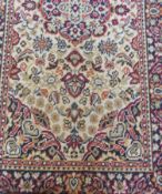 Oriental design wool rug, with ivory field, central medallion, overall floral pattern within