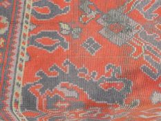 A Persian design wool rug, red field, within multiple borders