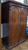 Mid-Victorian mahogany wardrobe, with raised ovolo and cavetto cornice, fitted with rail enclosed by