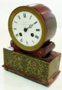 A nineteenth century style mantel clock with circular enamel dial raised on a plinth base with