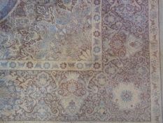 An Oriental design carpet, with ivory field, an overall floral pattern with central medallion and