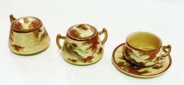 Japanese Satsuma pottery trio: cup, saucer, cream jug and sugar basin, all painted with autumn