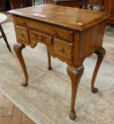 Reproduction figured walnut lowboy of early Georgian style, the top cross-banded, having ogee