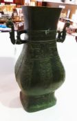 Chinese bronze vase of squared baluster form, with stylised dragon handles and decorated with taoist