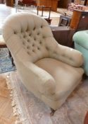 Victorian buttonback armchair, in modern beige upholstery, on turned supports and castors