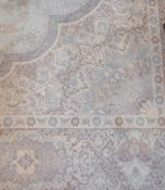 Large Oriental patterned rug, with pale blue central medallion with floral design, surrounded by a