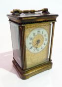 French carriage clock timepiece in brass case with glazed panels, the dial with enamelled chapter