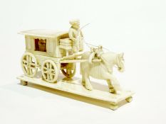 Carved ivory horse drawn carriage with driver (some parts missing), 11 cm long