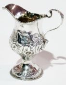 Georgian silver cream jug, footed, inverse pyriform, floral embossed with gadrooned border, London