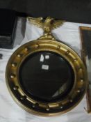 A Regency style wall mirror, circular with eagle surmount