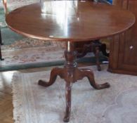 Georgian mahogany tilt-top tripod occasional table, on tapered and bulbous column tripod, scroll