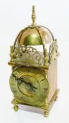 20th century brass lantern style clock with engraved and pierced fish pediment, French movement,