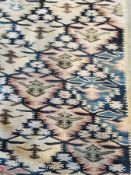 Oriental wool rug, the beige ground with overall patterns within multiple borders