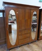 Early twentieth century mahogany compactum, with ogee and dentil cornice, herringbone frieze, fitted