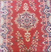 Oriental style wool runner, red field with central medallion, and floral decoration within