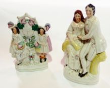 Staffordshire pottery flatback clock figure group, two girls carrying baskets of fruit with