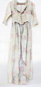 A Victorian cotton dress, pale blue ground with pink roses, the bodice and skirt attached, three-