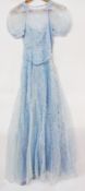A 1930's pale blue lace dress, with puff sleeves, sash, and a blue satin slip