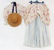 An antique French costume , bodice, skirt, petticoat and straw hat, the overskirt in a floral