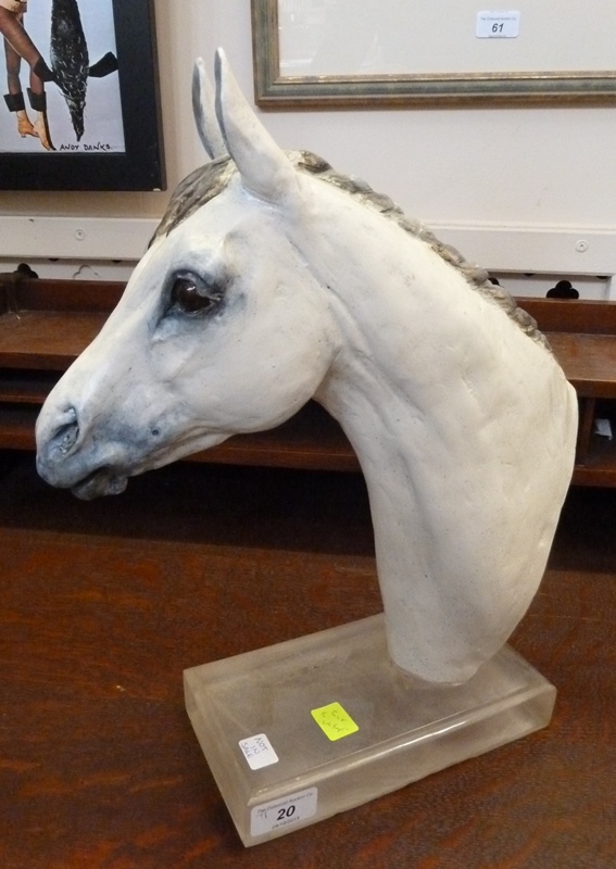 Contemporary ceramic sculpture of a horse's head, by Irene French, on a glass plinth